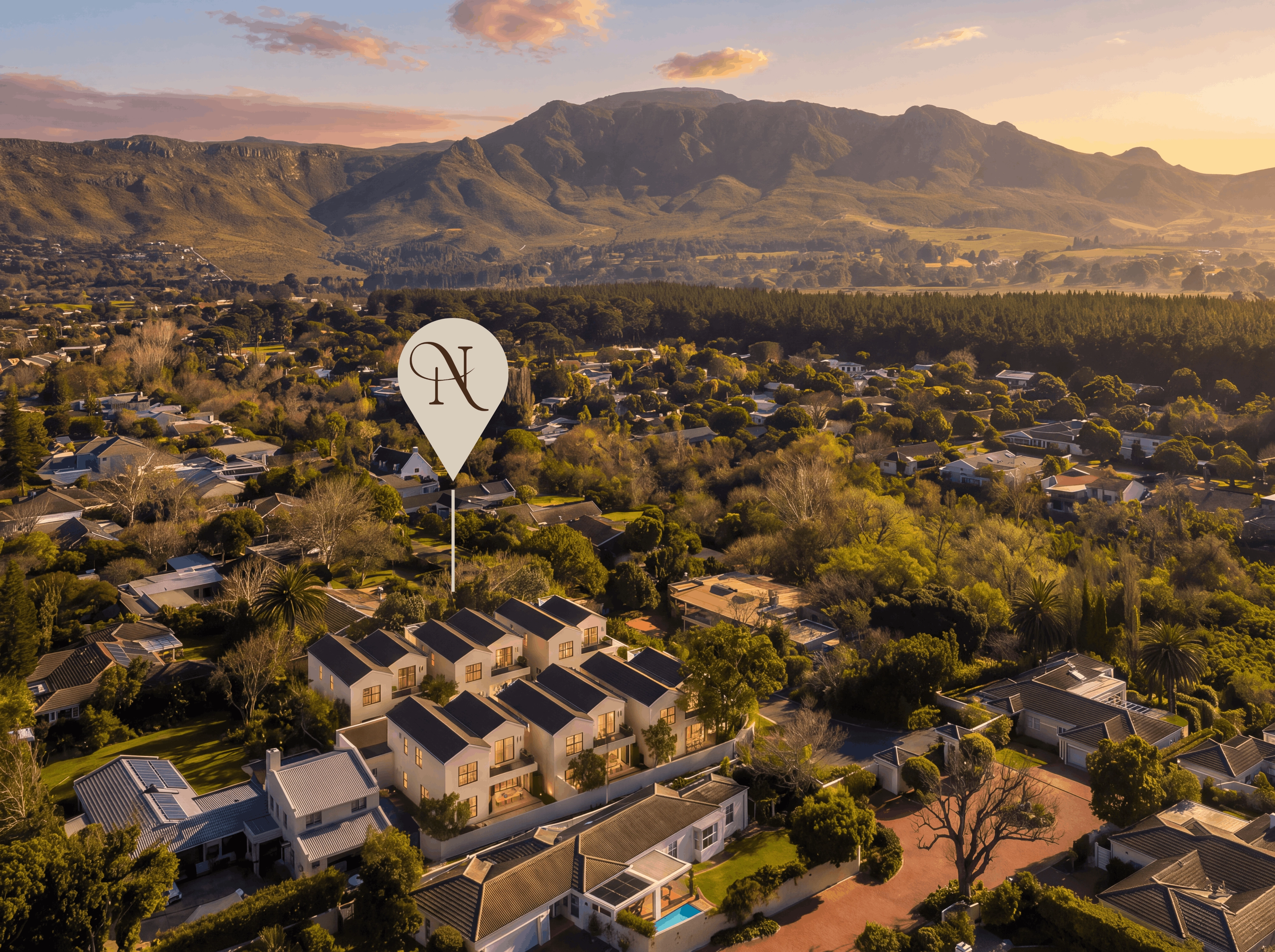 Aerial view over Dennendal at sunset, the estate marked below the mountains